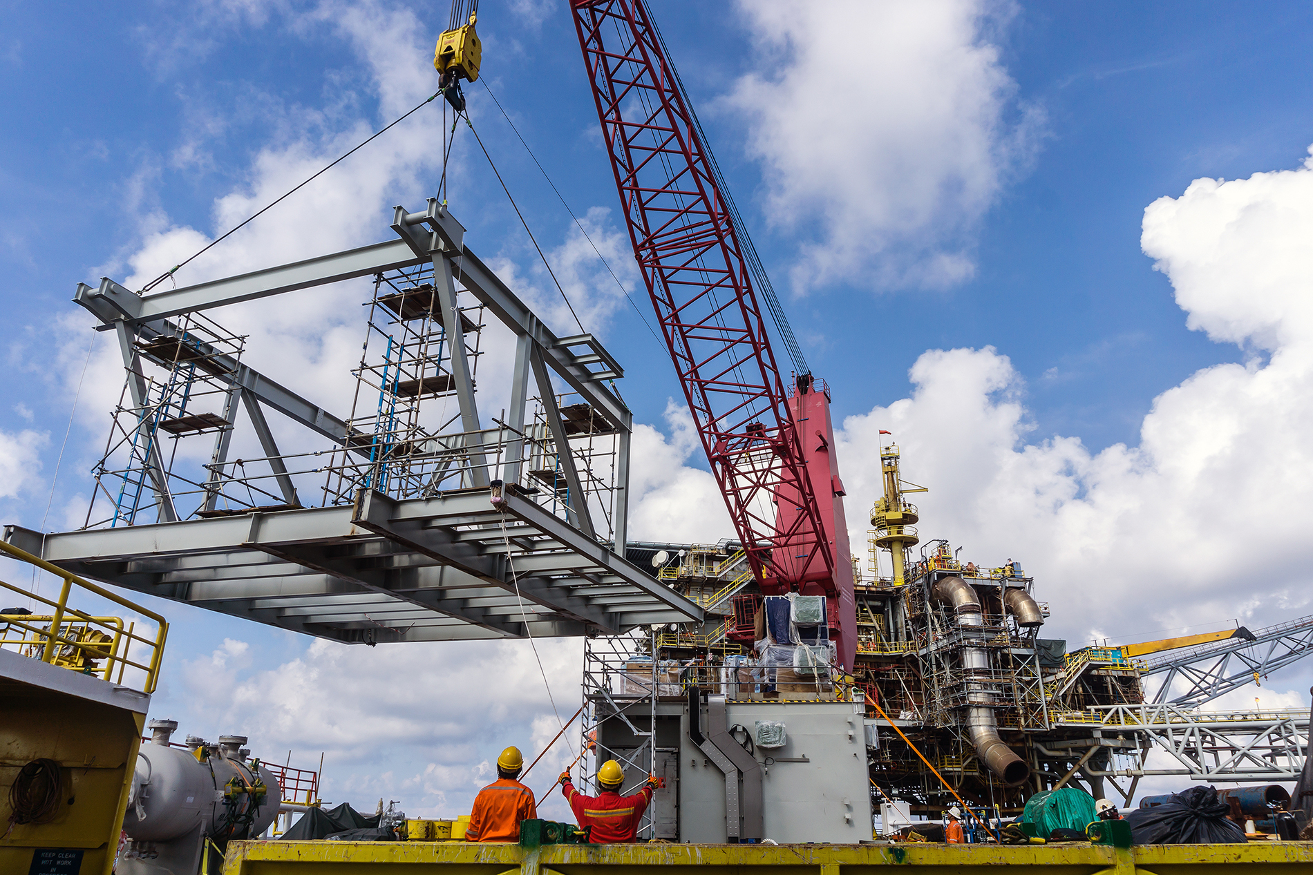 Offshore crane on board a construction work barge performing hea